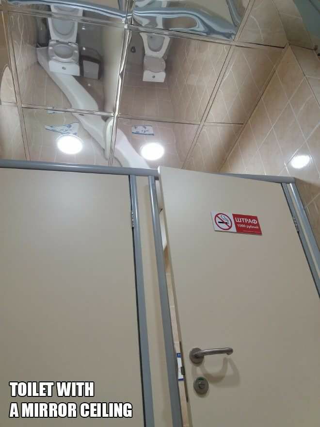 Toilet with mirror ceiling